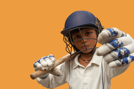 Portrait of boy wearing cricket Helmet and holding Bat