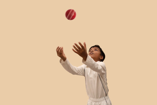 Boy catching cricket ball