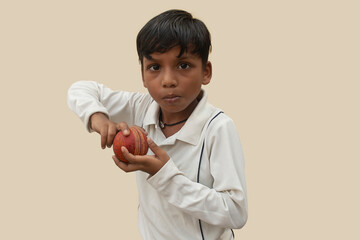 A boy in cricket uniform peppered bowling motion