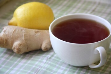 Black hot tea with fresh and natural lemon and ginger root is good for treating colds and viral diseases.