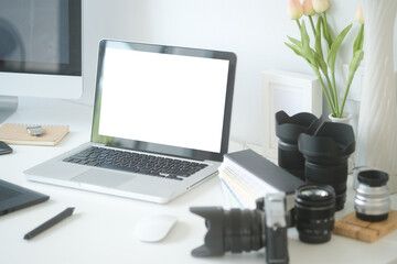 Graphic designer's or photographer workspace with laptop, computer, digital camera, digital tablet...