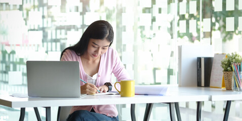 Portrait businesswoman using laptop for work on work space.