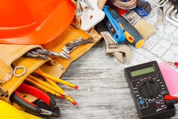 Different construction tools, wooden background
