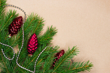Traditional green christmas tree noble fir border frame on craft paper background with copy space.