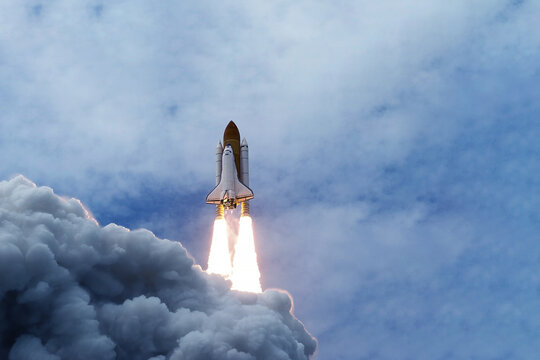The launch of the space shuttle against the background of the sky and smoke. Elements of this image furnished by NASA