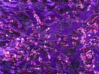 Purple sequined fabric texture - pink and purple sparkling sequins background. Festive, carnival or...