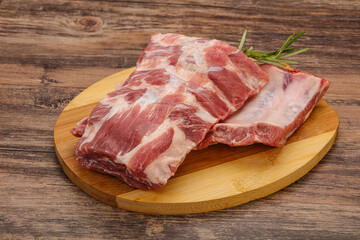 Raw pork ribs served rosemary