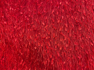 Red disco fabric texture - hairy eyelash fringe fabric background. Festive, carnival or fashion...