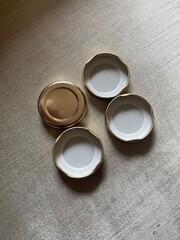 set of four golden white bottle caps with three upside down and one straight