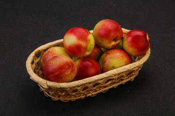 Sweet small nectarines in the basket