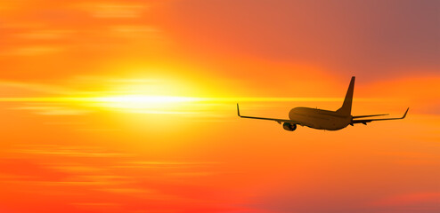 Airplane in the sky at sunset