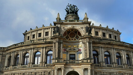Fototapeta na wymiar Nahansicht des Obergeschosses der Semperoper in Dresden mit Pantherquadriga vor blauem Himmel