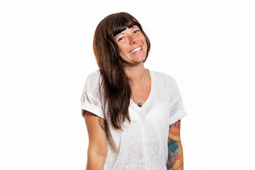 Close-up portrait of a happy smiling woman with piercings and tattoos. White background. Copy space. The concept of advertising and emotions