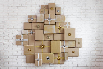 Many wrapped gifts with bows on brick wall