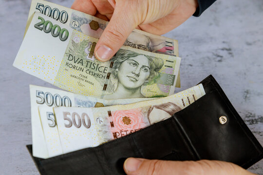 Hand of man who takes the Czech korun out of his wallet