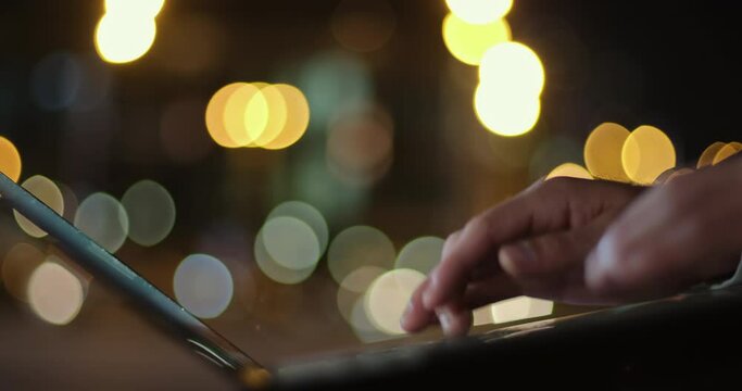 A man enters a password with one hand on a keyboard on a laptop and presses "enter". Does not work to log into the account, indignation with a hand gesture. The close up of hands, boke backgroud.