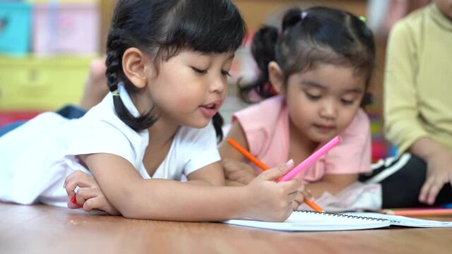 Children drawing and painting color on paper with happiness. 