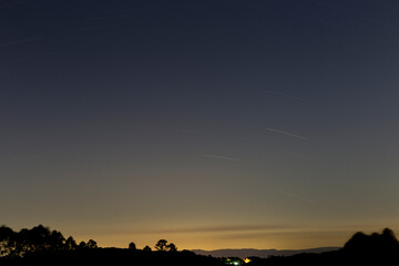 Sky with trail of stars, bluish sky with yellow tones