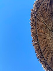 straw umbrella of blue sky