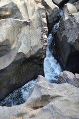 River stream flowing over rock formations in the mountains.