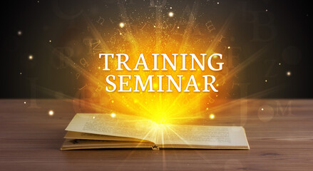 TRAINING SEMINAR inscription coming out from an open book, educational concept