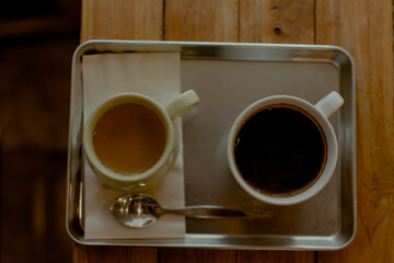 Hot coffee and tea on wooden table in cafe. Place for text. Banner Concept.