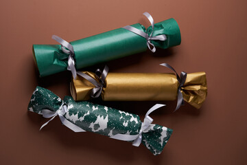 Candy shaped gift on brown background. Christmas or New Year decoration