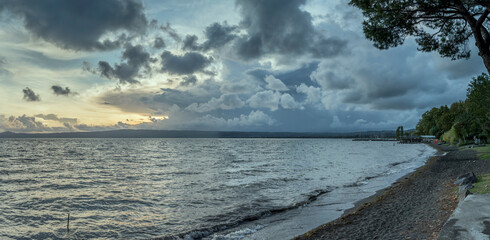 sunset storm clouds at lake shore,  Bolsena, Viterbo, Italy