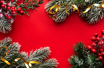 Fototapeta na wymiar Christmas red decorations, fir tree branches on red background