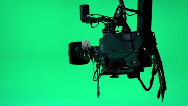 The camera jib is moving in a professional green screen studio. Film and Television Industry