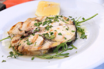 cod fish served on a white plate 