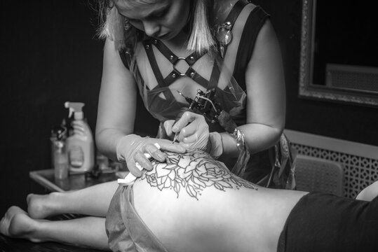 Professional tattoo artist create tattoo in tattoo parlour