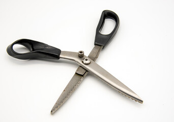 Old tailor scissors on a white background.