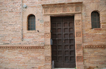 Ancient door in the city of Deruta decorated with raw ceramic