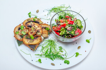 Sandwich with fried mushrooms, basil, pumpkin seeds and microgreens - radish and onion seedlings and tomato and cucumber salad, served with sesame seeds.