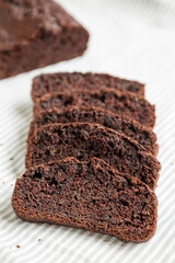 Homemade Chocolate Zucchini Bread on a rustic wooden board, side view. Close-up.