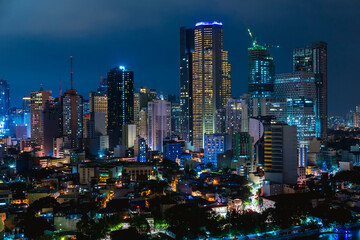 Makati, Metro Manila, Philippines - Nov 2020: Night view of North Makati's skyline as seen from the opposite side of the Pasig River. Gramercy Residences and Trump Tower are the tallest here.
