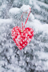 red heart on a tree in the snow