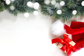 Christmas gifts, fir branch on a white background. Merry Christmas and Happy Holidays postcard, frame. Winter Christmas holiday theme. Flat lay, top view.