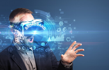 Businessman looking through Virtual Reality glasses with BROADBAND inscription, innovative technology concept