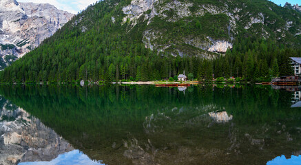 Braies Lake with forest on background. Colorful spring view of Italian Alps, Naturpark Fanes-Sennes-Prags, Dolomite, Italy, Europe. Traveling, ecological and photo tourism.