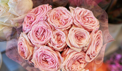 Beautiful bouquets of pink roses in a flower shop. A bright mix of flowers. Handsome fresh bouquets. Flowers delivery. Floral shop. Selective focus.