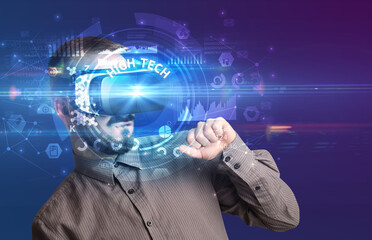 Businessman looking through Virtual Reality glasses with HIGH-TECH inscription, innovative technology concept