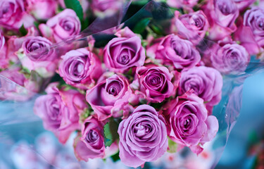 Beautiful bouquets of pink roses in a flower shop. A bright mix of flowers. Handsome fresh bouquets. Flowers delivery. Floral shop. Selective focus.