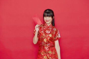 Young Asian woman wear a Chinese dress with a red envelope