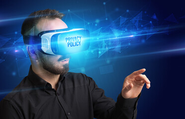 Businessman looking through Virtual Reality glasses with PRIVACY POLICY inscription, cyber security concept