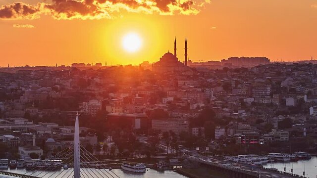 Sun is setting down behind Fatih Mosque. 4K time lapse panorama clip with Halic metro bridge. Taken from Galata Tower, Istanbul, Turkey