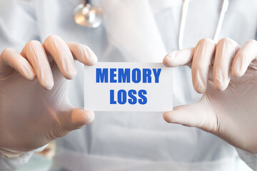 Doctor holding a card with text MEMORY LOSS