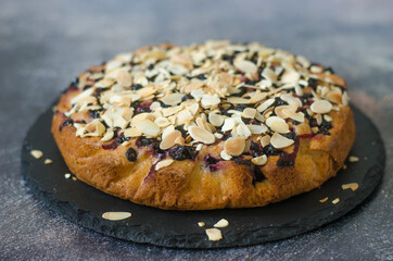 Pie with black currant and almond petals