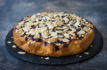 Pie with black currant and almond petals